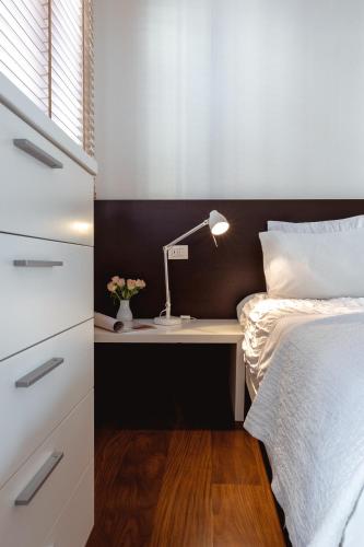 a bedroom with a bed and a desk with a lamp at Casa Bembo in Asolo