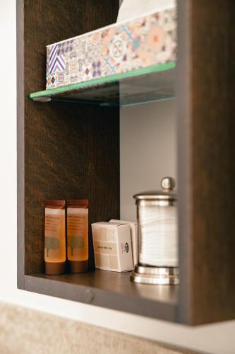 a shelf with toiletries on it in a bathroom at Casa Bembo in Asolo