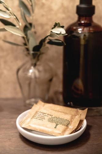 a napkin on a plate next to a bottle of wine at Casa Bembo in Asolo