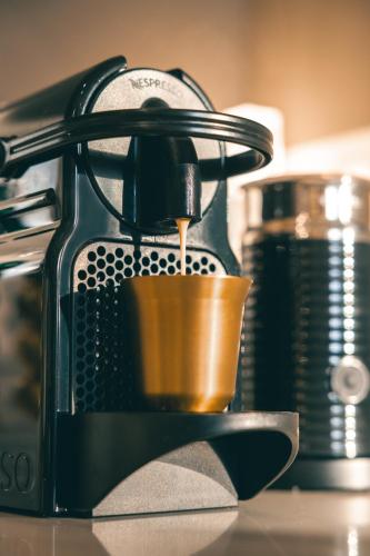 a coffee maker pouring coffee into a cup at Casa Bembo in Asolo