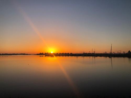 a sunset over a large body of water at Schleivilla Hafenmeister in Kappeln