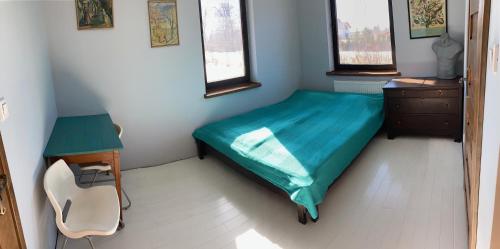 a bedroom with a bed and a desk and a chair at Chata na Łąkach in Jerzmanowice