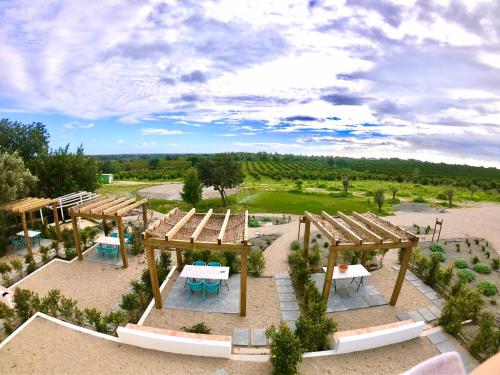 - une vue aérienne sur un parc avec des tables et des chaises dans l'établissement Tavira-Quinta da Janela Azul, à Tavira