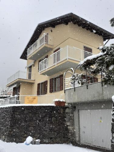 a large house in the snow with at B&B-FORESTERIA Casa Della Musica Lake Como in Mandello del Lario