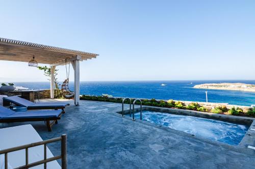 a swimming pool with a view of the ocean at Eden View Suites & Villas in Paradise Beach