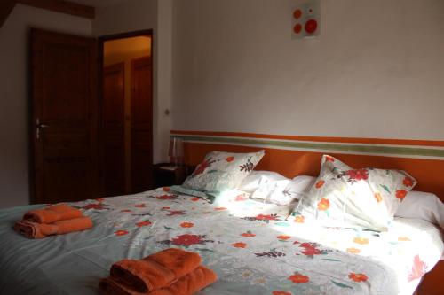 a bedroom with a bed with towels on it at la grange avec spa in Saint-Aventin