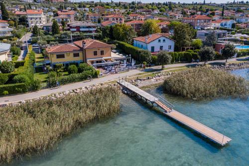 an aerial view of a river with a pier at Locanda Le Palafitte in Bardolino