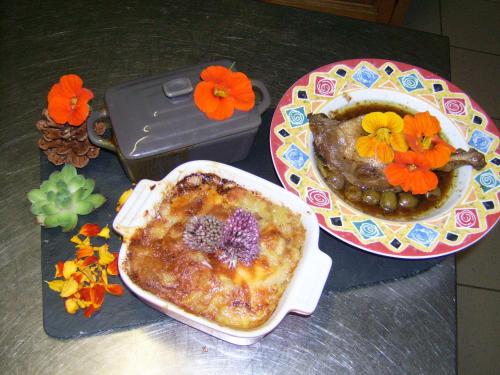 a table with a plate of food and a bowl of food at Chez Louis chambres d'hôtes à la ferme in La Canourgue