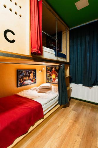 a bedroom with a bed with a red comforter at Good Times House in Katowice