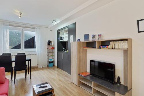 a living room with a flat screen tv and a table at Modern studio in Arinsal of 40 m² with mountain view in Arinsal