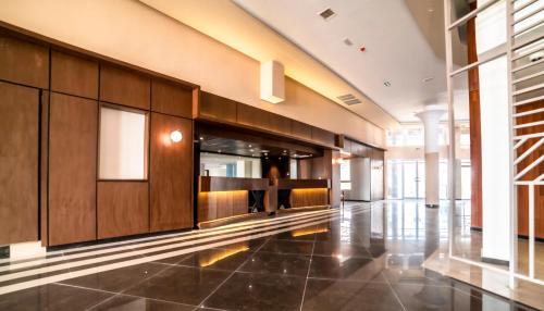 a hallway of a building with wooden cabinets and tile floors at Best Western Plus Soaho Douala Airport in Douala