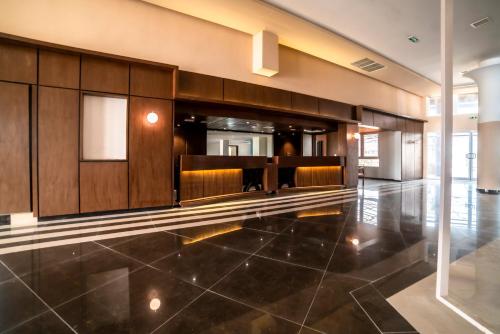 a lobby with a row of chairs in a building at Best Western Plus Soaho Douala Airport in Douala