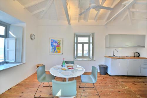 a kitchen and dining room with a table and chairs at Villa Loukia in Hydra