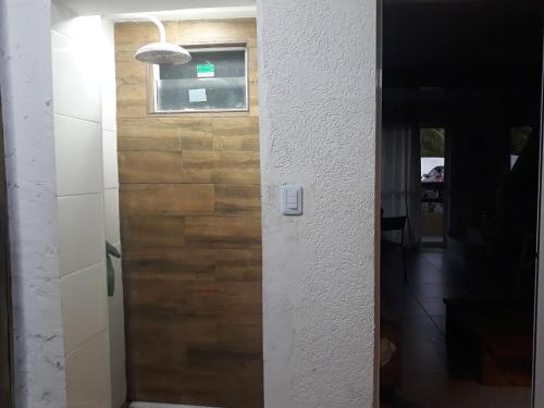 a door to a kitchen with a wooden wall at Summer Houses Itacimrim in Itacimirim