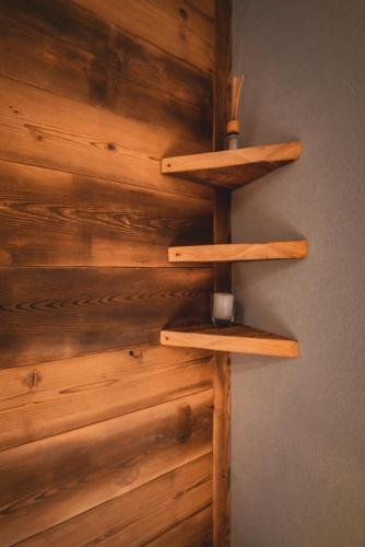 a wall with wooden shelves on a wall at Chalet Della Guida in Bardonecchia