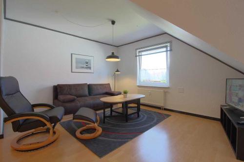 a living room with a couch and a table at FeWo Leuchtturm Wremen in Wremen