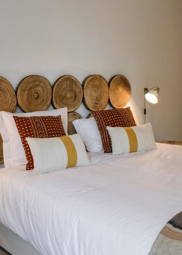 a bedroom with a large white bed with wooden headboards at Casa de Férias - Troia Terrace Lake & Pool - Soltroia Comporta Aluguer in Troia