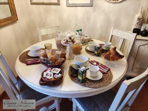 a white table with food on top of it at Casa Nives in San Pietro in Casale