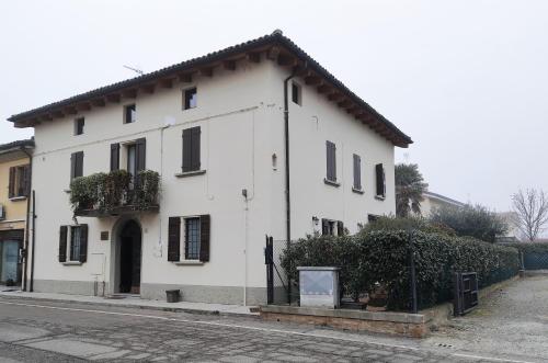 a white building on the side of a street at Casa Nives in San Pietro in Casale