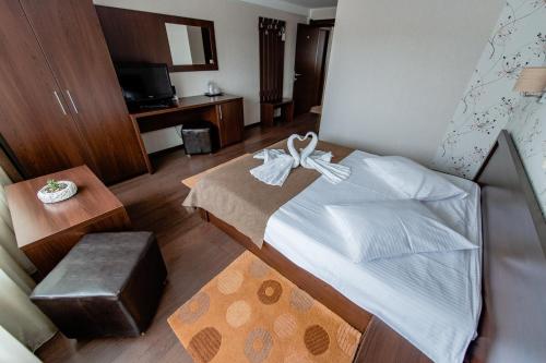 a bedroom with a bed with a bow on it at Vila Hera Luxury in Predeal