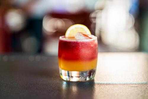 a drink sitting on a table with a lemon slice at Cambria Hotel Downtown Asheville in Asheville