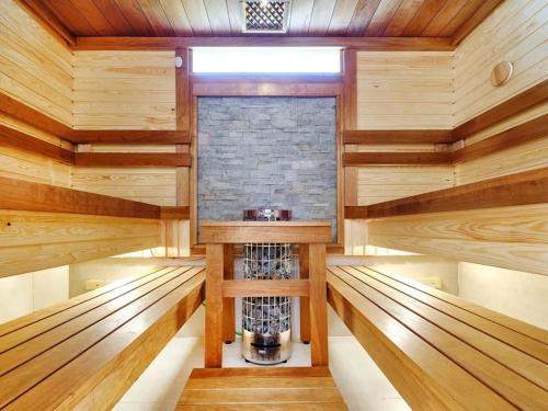 a sauna with wood paneling and a brick wall at Apartamento con solarium Villa Amalia in Torrevieja