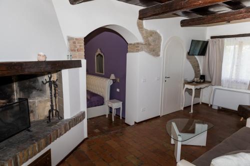 a living room with a fireplace and a couch at Villa Ca' Viola Rimini in Rimini
