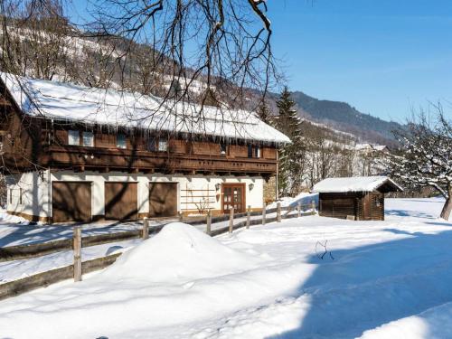 a snow covered house with a fence in front of it at Ferienhaus Pichl in Bruck an der Großglocknerstraße