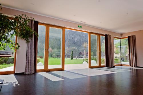 an empty living room with large glass doors at Penzion Repnik in Kamnik