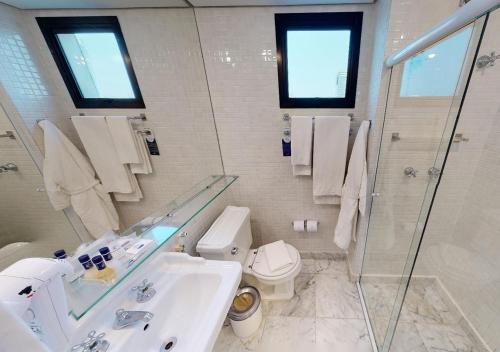 a bathroom with a sink and a toilet and a shower at Estanplaza Berrini in Sao Paulo
