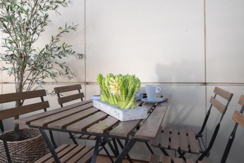 a wooden table with chairs and a plant on it at Pacificio Beachfront in Málaga