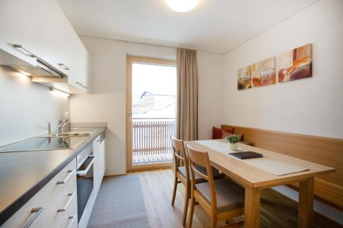 a small kitchen with a table and a sink at Appartements Berg 170 in Damuls