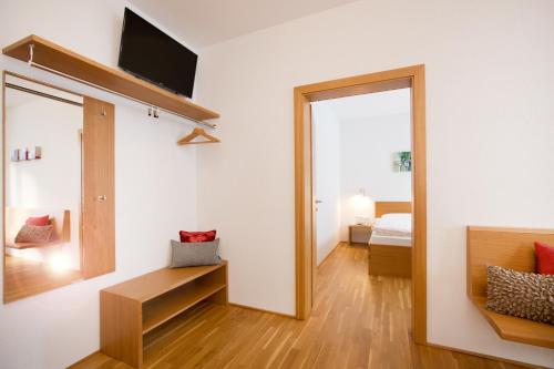 a living room with a mirror and a bed at Appartements Berg 170 in Damuls