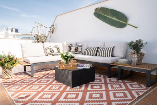 a living room with a couch and a table at Pacificio Beachfront in Málaga