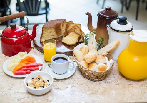 a table with a breakfast of toast and coffee and orange juice at Estanplaza Nações Unidas in Sao Paulo