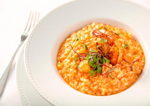 a bowl of seafood risotto with shrimp and herbs at Estanplaza Nações Unidas in Sao Paulo