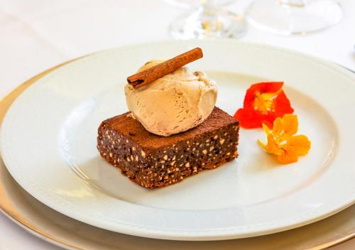 a white plate with a piece of cake and ice cream at Estanplaza Nações Unidas in Sao Paulo