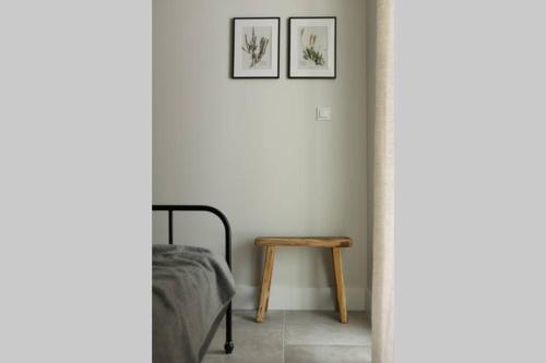 a bedroom with a bed and a wooden table at Nowoczesny apartament w Puszczy Białowieskiej in Hajnówka