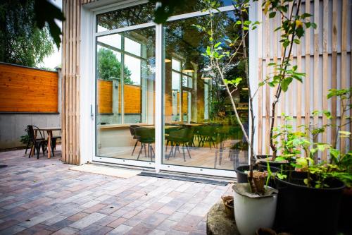 a patio with a glass door with a table and chairs at Salon Win Wine Bar & Apartments in Jasło