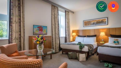 a hotel room with two beds and a table at Clayton Hotel & Leisure Club Sligo in Sligo