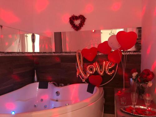 a bathroom with a tub with hearts on the wall at Palese Profumo di Mare in Santo Spirito