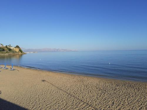 a beach with chairs and the ocean on a sunny day at LA FINESTRA SUL MARE PIANO Terra in Trappeto