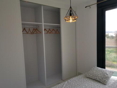 a bedroom with white closets with a bed and a window at Luxury apartment Maracuya Javea Port in Jávea