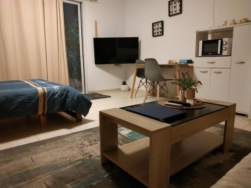 a living room with a coffee table and a tv at Cute Apartment hagoshrim in Hagoshrim