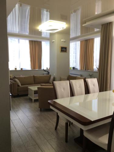 a living room with a table and a couch at Сдается уютная двухкомнатная квартира с джакузи в Батуми in Batumi