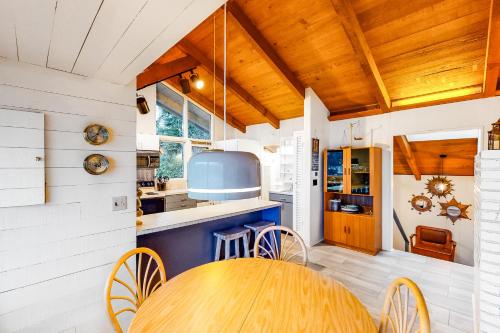 a kitchen with a wooden table and a counter at Delake House in Otis