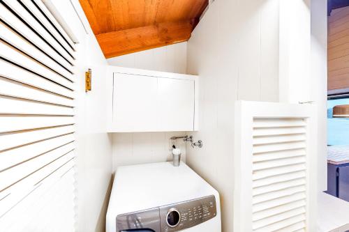 a small laundry room with a washer and dryer at Delake House in Otis