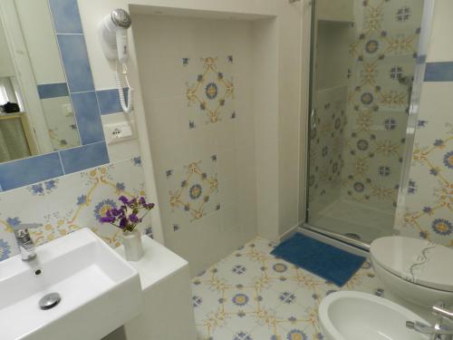 a bathroom with a shower and a sink and a toilet at A Pochi Metri Dal Mare in Marina di Mancaversa