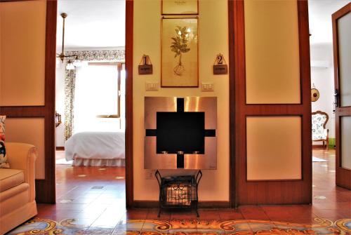 a living room with a tv on the wall at La terrazza di Anna in Sassari