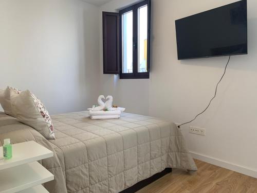 Cama o camas de una habitación en Remolars Sevilla